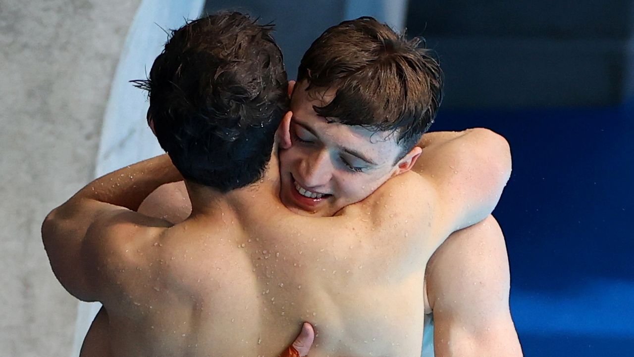 Tokyo 2020 Olympics - Diving - Men's 10m Platform Synchro - Final - Tokyo Aquatics Centre, Tokyo, Japan July 26, 2021. Thomas Daley of Britain and Matty Lee of Britain embrace each other REUTERS/Marko Djurica