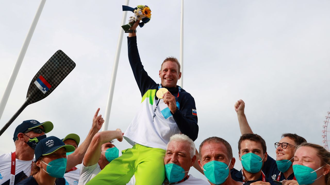 Tokyo 2020 Olympics - Canoe Slalom - Men's C1 - Medal Ceremony - Kasai Canoe Slalom Centre, Tokyo, Japan - July 26, 2021. Gold medallist Benjamin Savsek of Slovenia celebrates with his medal and team REUTERS/Yara Nardi