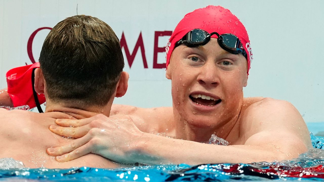 Tokyo 2020 Olympics - Swimming - Men's 200m Freestyle - Final - Tokyo Aquatics Centre - Tokyo, Japan - July 27, 2021. Tom Dean of Britain celebrates with Duncan Scott of Britain after winning the event REUTERS/Aleksandra Szmigiel