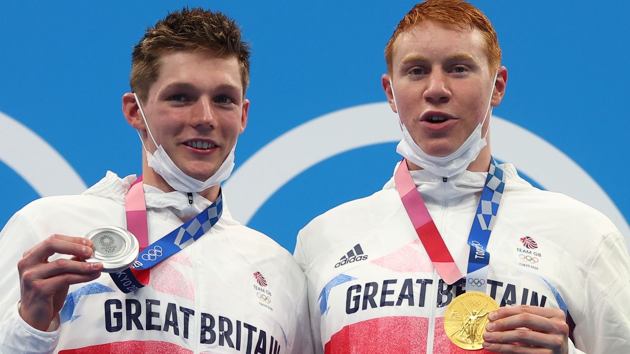 Tokyo 2020 Olympics - Swimming - Men's 200m Freestyle - Medal Ceremony - Tokyo Aquatics Centre - Tokyo, Japan - July 27, 2021. Tom Dean of Britain and Duncan Scott of Britain pose with their gold and silver medal REUTERS/Kai Pfaffenbach