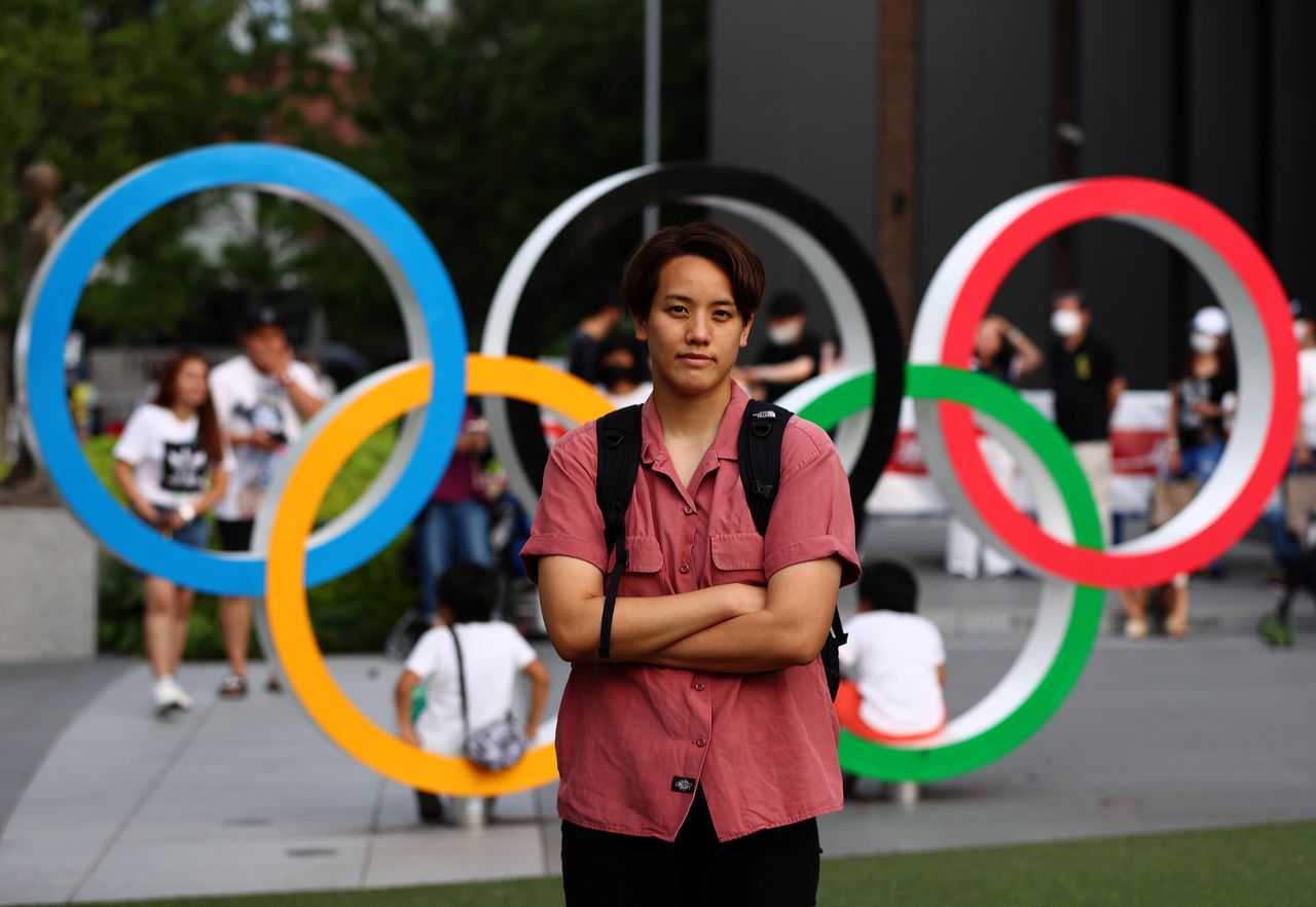 Arisa Tsubata, a nurse and a boxer, poses in front of the Olympic Rings outside the National Stadium, the main venue of the Tokyo 2020 Olympic Games, during an interview with Reuters in Tokyo, Japan, July 26, 2021. Picture taken on July 26, 2021. REUTERS/Kim Kyung-Hoon