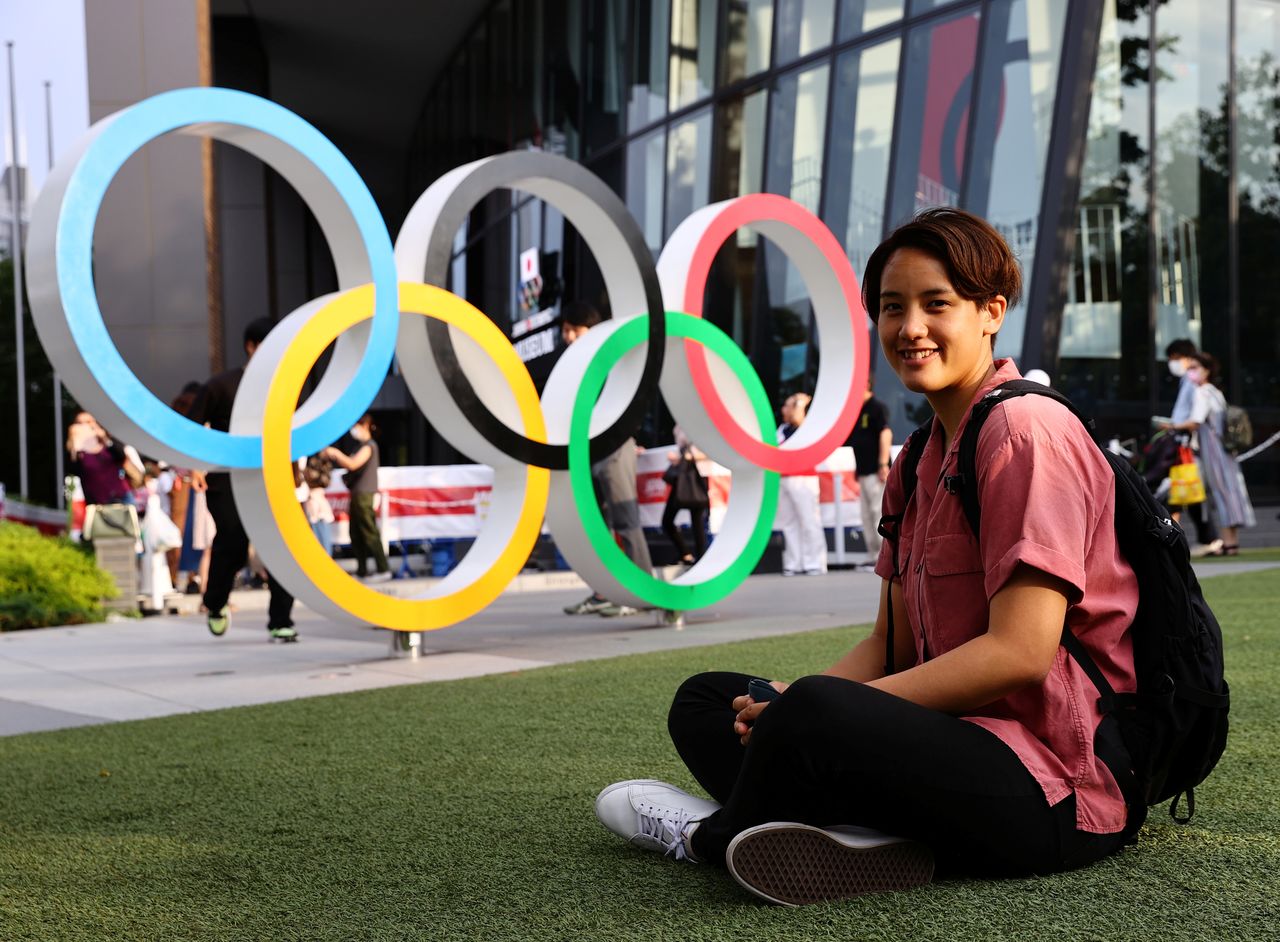 Arisa Tsubata, a nurse and a boxer, poses in front of the Olympic Rings outside the National Stadium, the main venue of the Tokyo 2020 Olympic Games, during an interview with Reuters in Tokyo, Japan, July 26, 2021. Picture taken on July 26, 2021. REUTERS/Kim Kyung-Hoon
