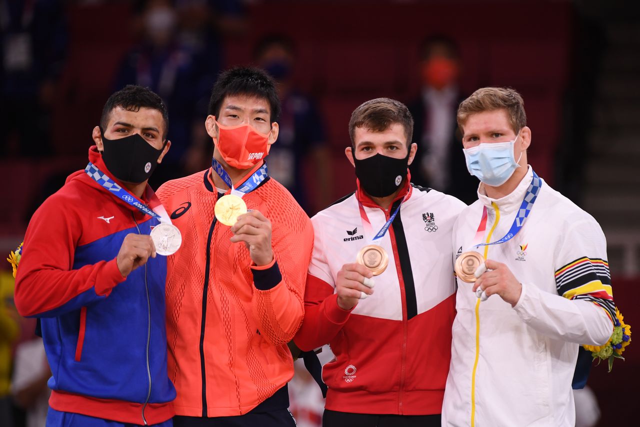 Tokyo 2020 Olympics - Judo - Men's 81kg - Medal Ceremony - Nippon Budokan - Tokyo, Japan - July 27, 2021. Gold medallist Takanori Nagase of Japan, silver medallist Saeid Mollaei of Mongolia, bronze medallist Shamil Borchashvili of Austria, and bronze medallist Matthias Casse of Belgium wearing protective face masks pose with their medals REUTERS/Annegret Hilse