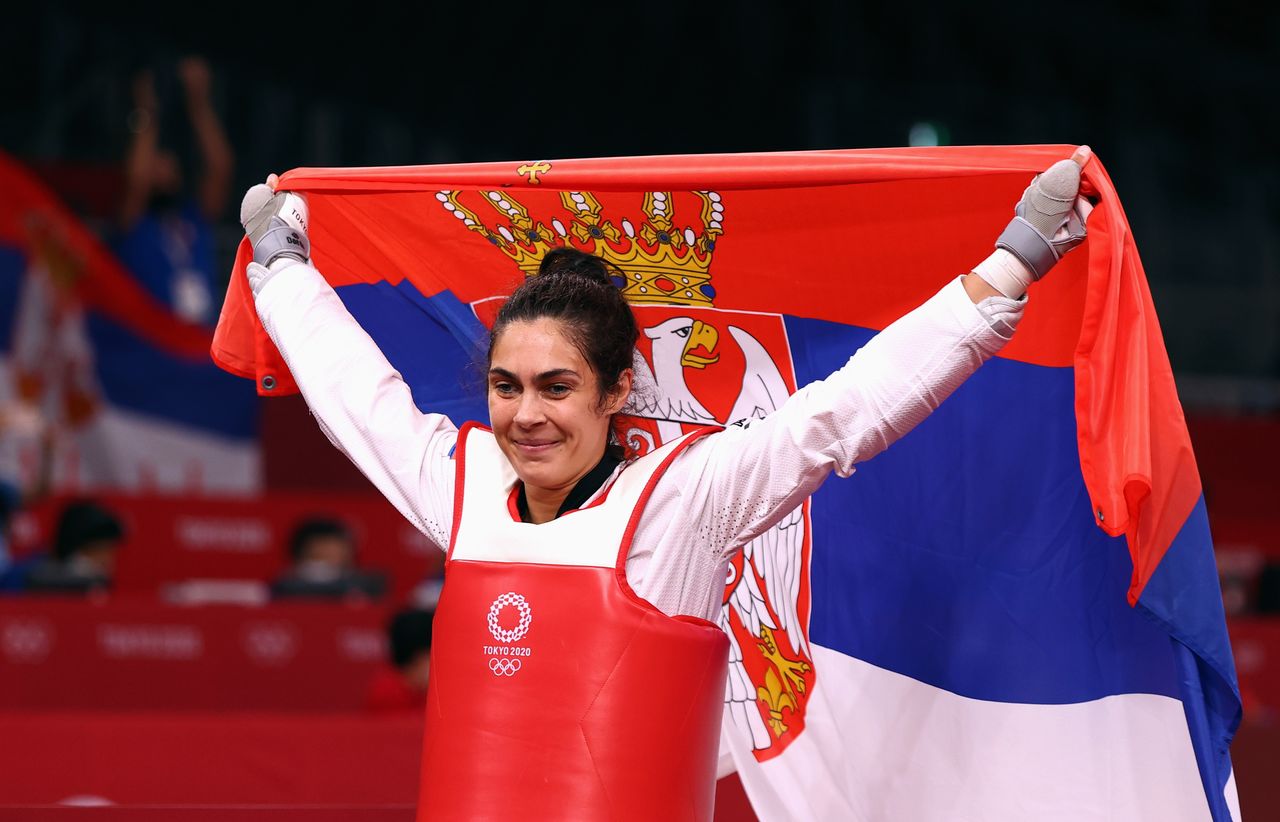 Tokyo 2020 Olympics - Taekwondo - Women's Heavyweight +67kg - Gold medal match - Makuhari Messe Hall A, Chiba, Japan - July 27, 2021. Milica Mandic of Serbia celebrates winning gold with the Serbian flag REUTERS/Murad Sezer