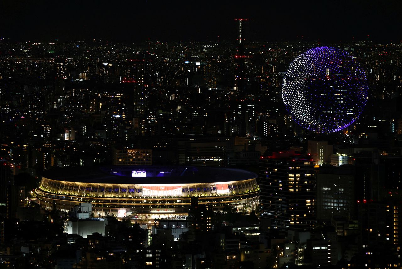 FILE PHOTO: The Tokyo 2020 Olympics Opening Ceremony - Olympic Stadium, Tokyo, Japan - July 23, 2021. Drones form a shape of the world during the opening ceremony, seen above the Olympic Stadium REUTERS/Kim Kyung-Hoon/File Photo