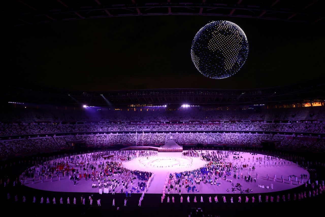 FILE PHOTO: The Tokyo 2020 Olympics Opening Ceremony - Olympic Stadium, Tokyo, Japan - July 23, 2021. Drones are seen above the stadium during the opening ceremony REUTERS/Marko Djurica/File Photo