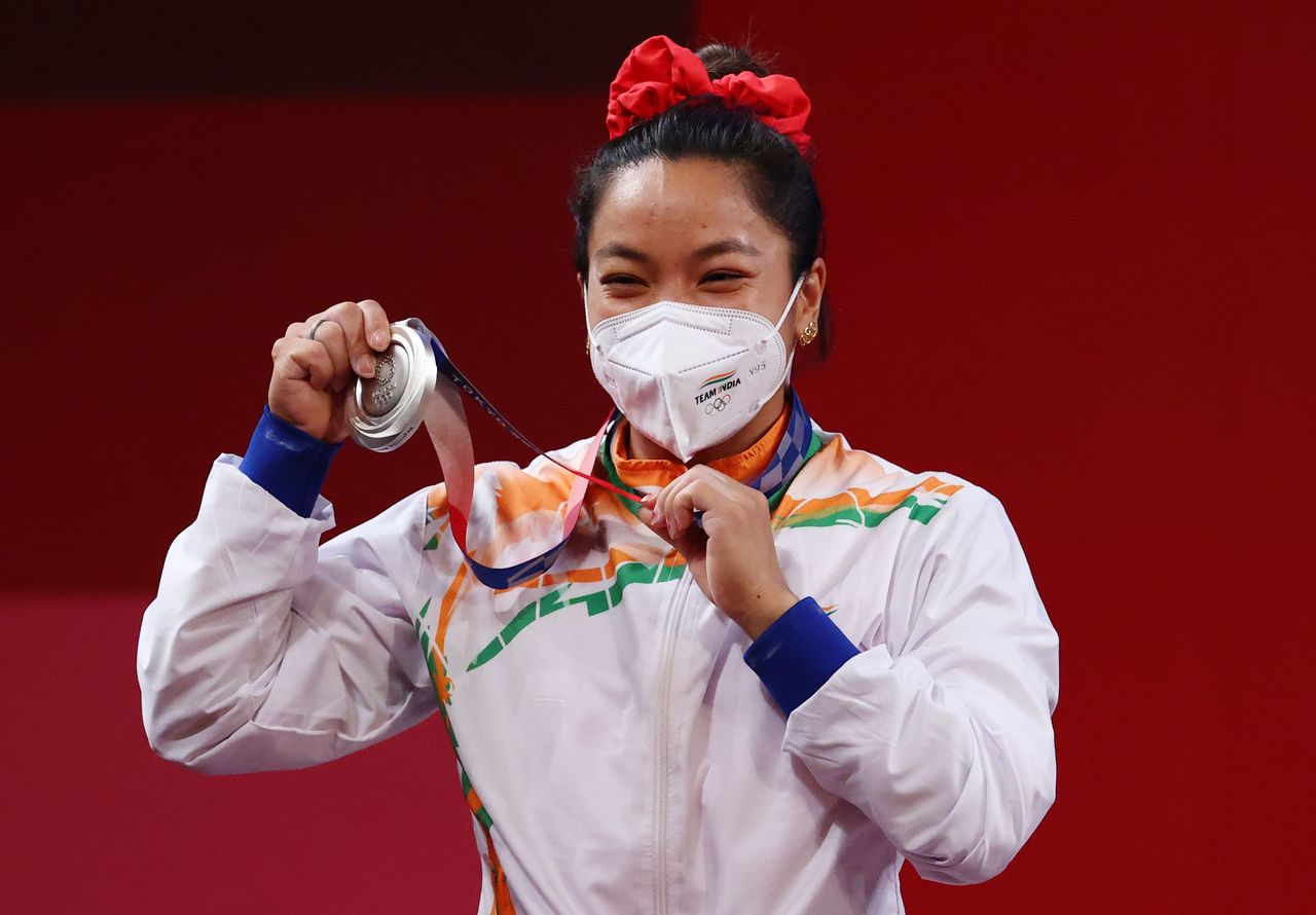 Tokyo 2020 Olympics - Weightlifting - Women's 49kg - Medal Ceremony - Tokyo International Forum, Tokyo, Japan - July 24, 2021. Silver medalist Mirabai Chanu Saikhom of India reacts. REUTERS/Edgard Garrido