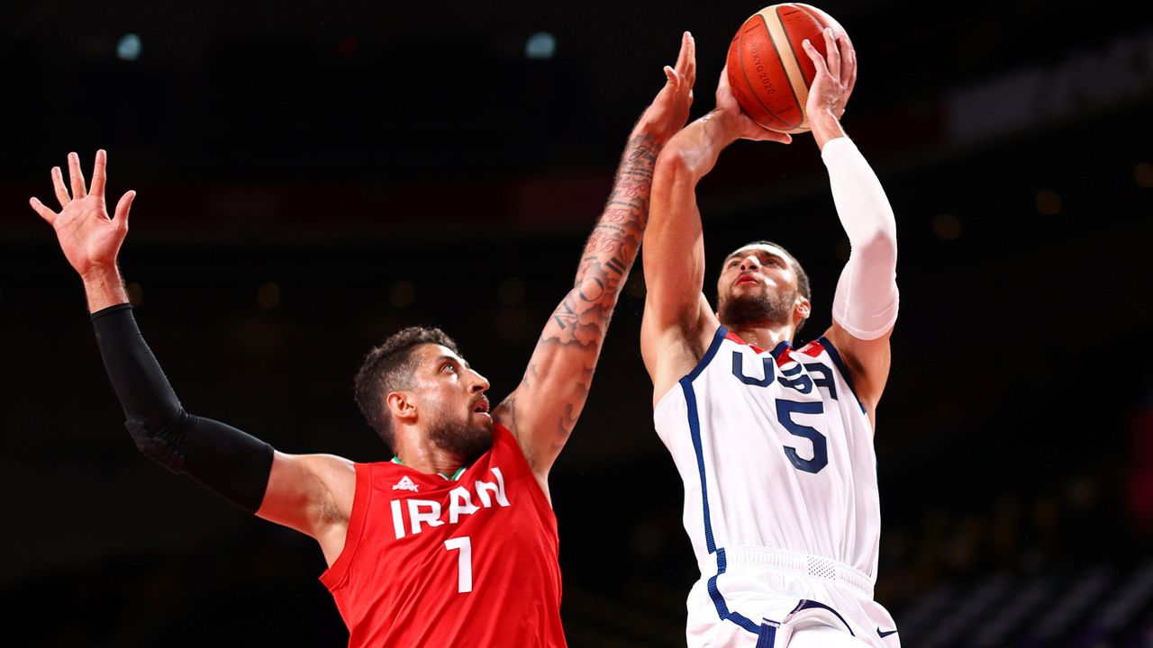 Tokyo 2020 Olympics - Basketball - Men - Group A - United States v Iran - Saitama Super Arena, Saitama, Japan - July 28, 2021. Zach Lavine of the United States in action with Mohammad Hassanzadeh of Iran REUTERS/Brian Snyder