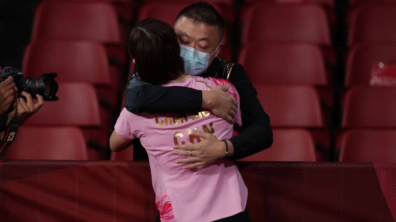 Tokyo 2020 Olympics - Table Tennis - Women's Singles - Gold medal match - Tokyo Metropolitan Gymnasium - Tokyo, Japan - July 29, 2021. Chen Meng of China celebrates with coach Ma Lin after winning her match against Sun Yingsha of China REUTERS/Hannah Mckay
