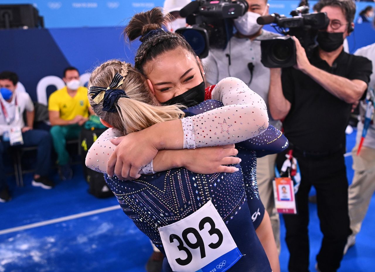 Tokyo 2020 Olympics - Gymnastics - Artistic - Women's Individual All-Around - Final - Ariake Gymnastics Centre, Tokyo, Japan - July 29, 2021. Sunisa Lee of the United States wearing a protective face mask is congratulated by Jade Carey of the United States after winning gold REUTERS/Dylan Martinez