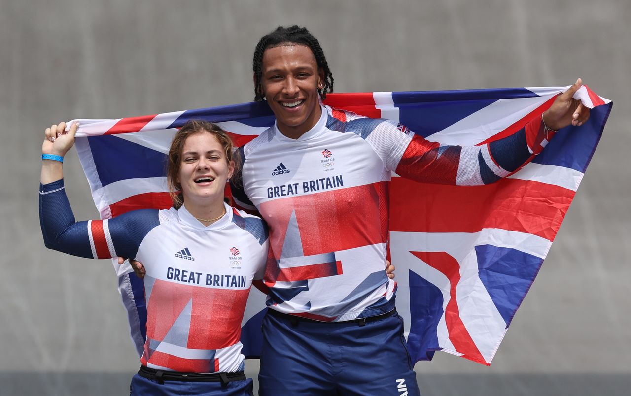 Tokyo 2020 Olympics - BMX Racing - Women's Individual - Final - AUP - Ariake Urban Sports Park, Tokyo, Japan - July 30, 2021. Women's Individual gold medallist Bethany Shriever of Britain celebrates alongside Men's Individual silver medallist Kye Whyte of Britain REUTERS/Christian Hartmann