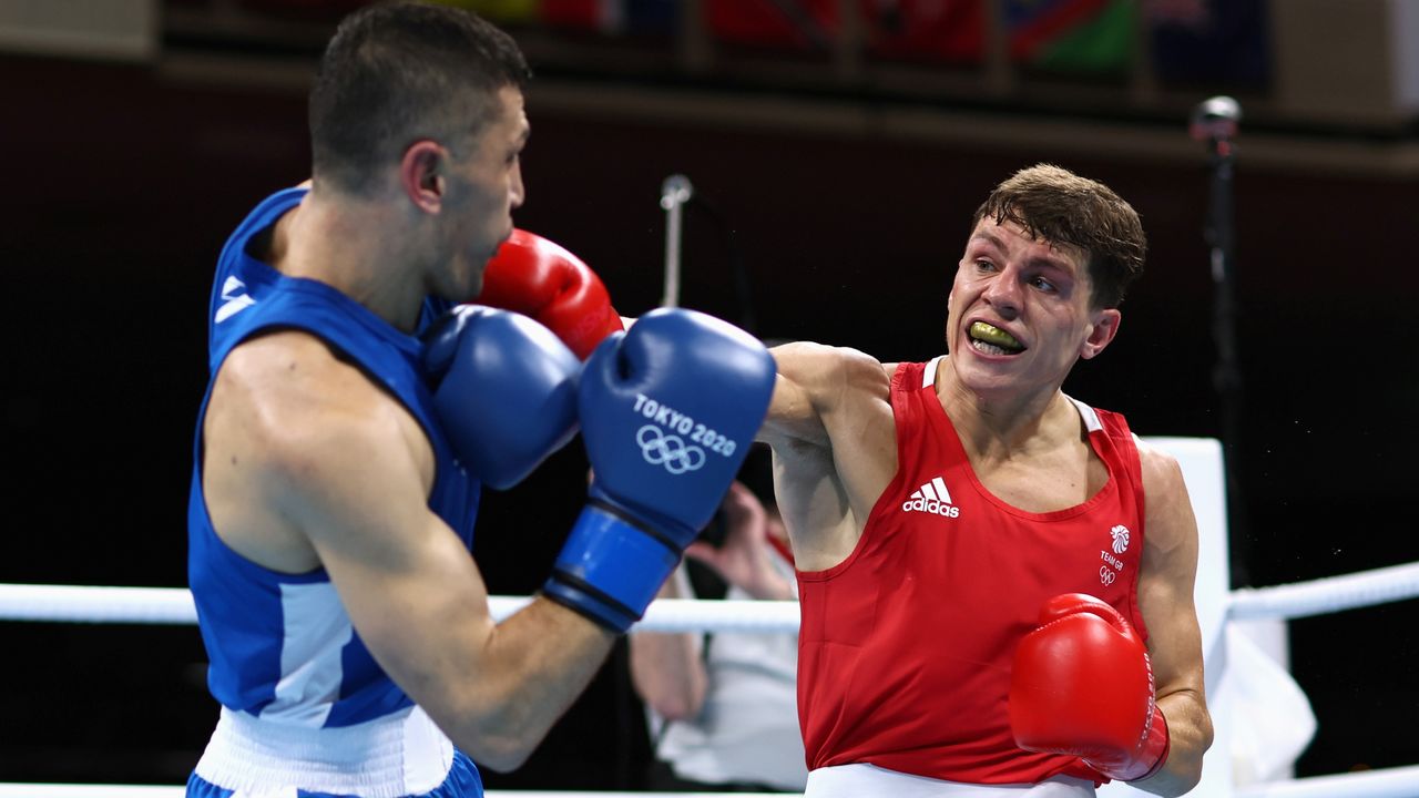 Tokyo 2020 Olympics - Boxing - Men's Welterweight - Quarterfinal - Kokugikan Arena - Tokyo, Japan - July 30, 2021. Bobo Usmon Baturov of Uzbekistan and Pat McCormack of Britain in action. Pool via REUTERS/Buda Mendes