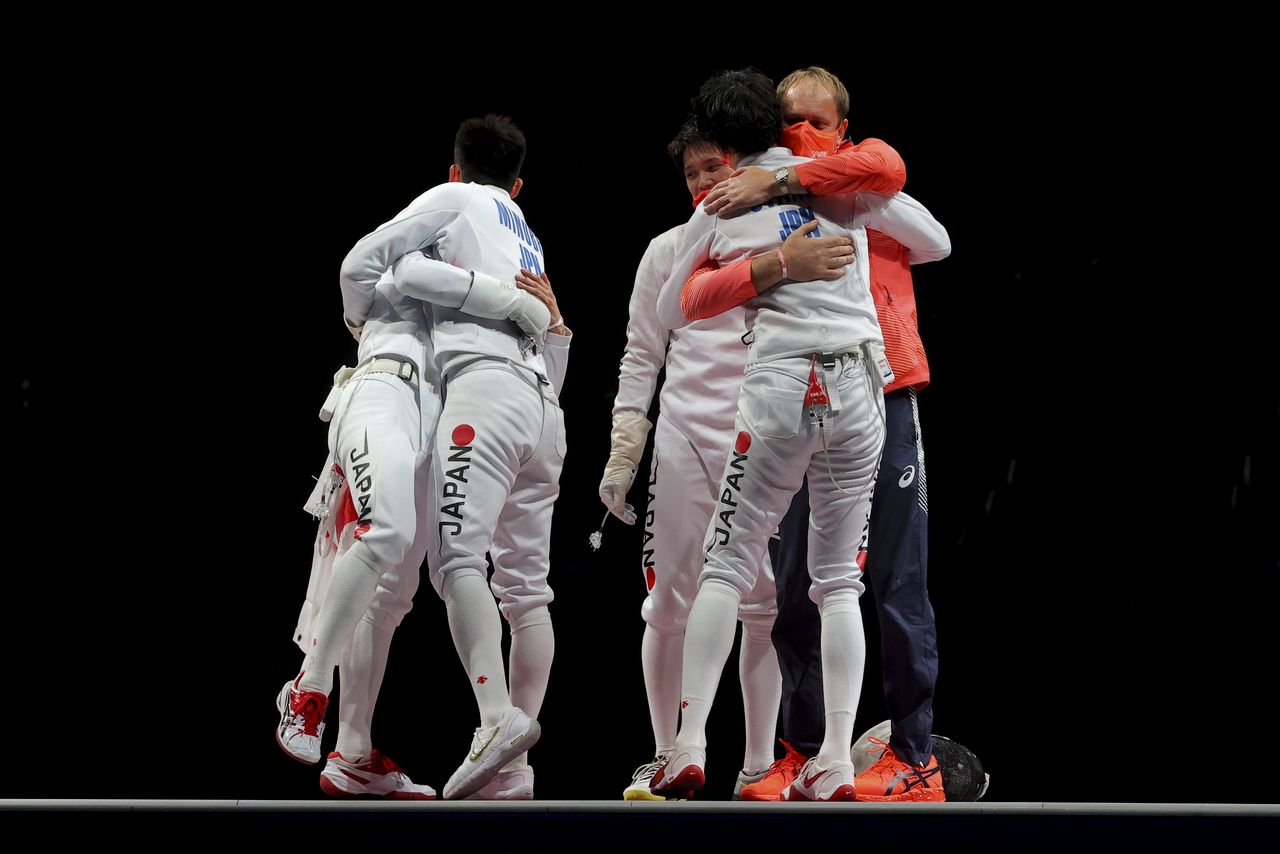Tokyo 2020 Olympics - Fencing - Men's Team Epee - Gold medal match - Makuhari Messe Hall B - Chiba, Japan - July 30, 2021. Koki Kano of Japan, Kazuyasu Minobe of Japan, Masaru Yamada of Japan and Satoru Uyama of Japan celebrate with team members after winning gold REUTERS/Maxim Shemetov
