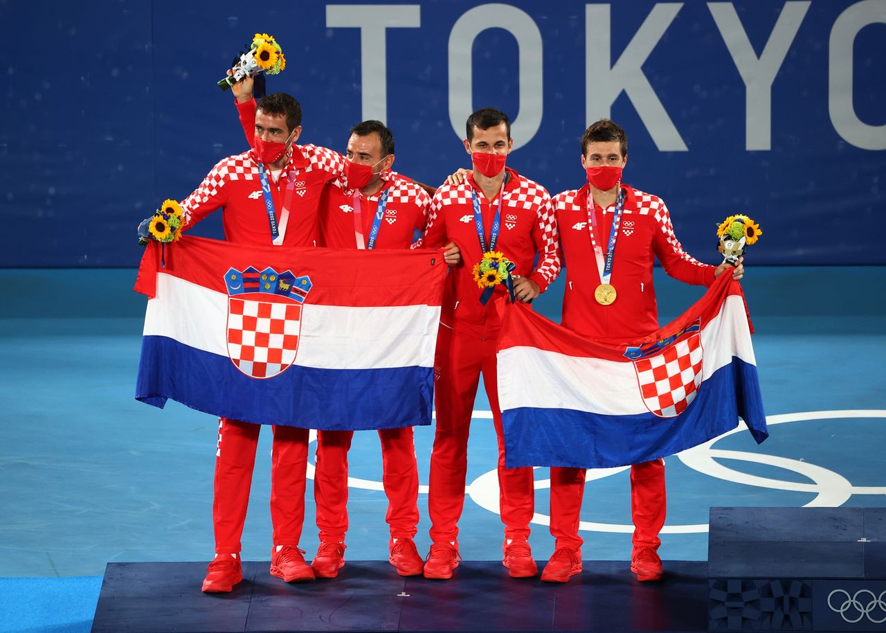 Tokyo 2020 Olympics - Tennis - Men's Doubles - Medal Ceremony- Ariake Tennis Park - Tokyo, Japan - July 30, 2021. Gold medallists Mate Pavic of Croatia and Nikola Mektic of Croatia celebrate on the podium with silver medallists, Ivan Dodig of Croatia and Marin Cilic of Croatia REUTERS/Mike Segar