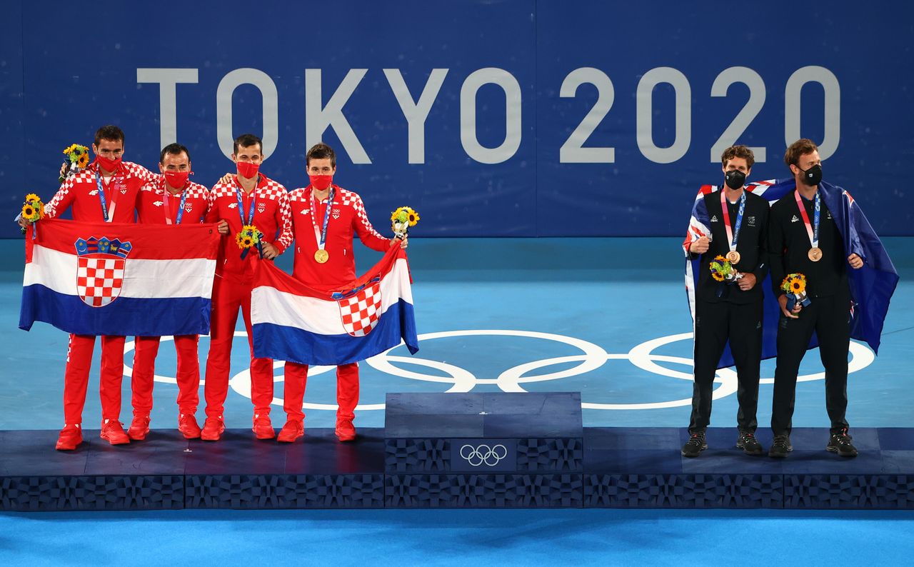 Tokyo 2020 Olympics - Tennis - Men's Doubles - Medal Ceremony- Ariake Tennis Park - Tokyo, Japan - July 30, 2021. Gold medallists Mate Pavic of Croatia and Nikola Mektic of Croatia with silver medallists, Ivan Dodig of Croatia and Marin Cilic of Croatia celebrate on the podium with bronze medallists Marcus Daniell of New Zealand and Michael Venus of New Zealand REUTERS/Mike Segar
