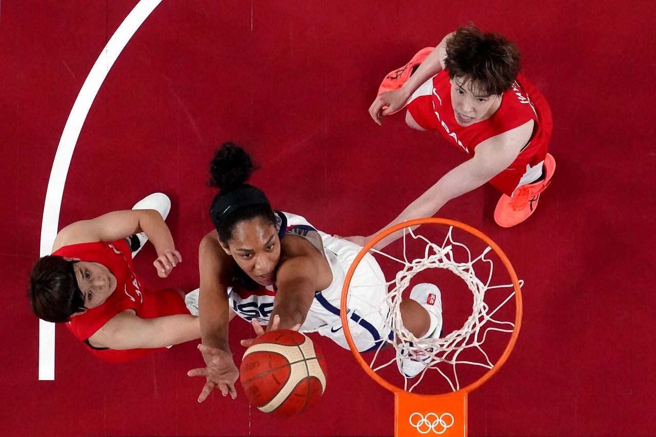 Tokyo 2020 Olympics - Basketball - Women - Group B - United States v Japan - Saitama Super Arena, Saitama, Japan - July 30, 2021. Saki Hayashi of Japan ans Rui Machida of Japan in action with A'Ja Wilson of the United States REUTERS/Brian Snyder