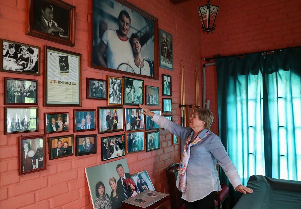Legendary Soviet gymnast Larisa Latynina, who holds the record for the most Olympic gold medals won by a gymnast, shows her pictures in home, in village Kalyanino, Moscow region, Russia July 30, 2021. REUTERS/Evgenia Novozhenina