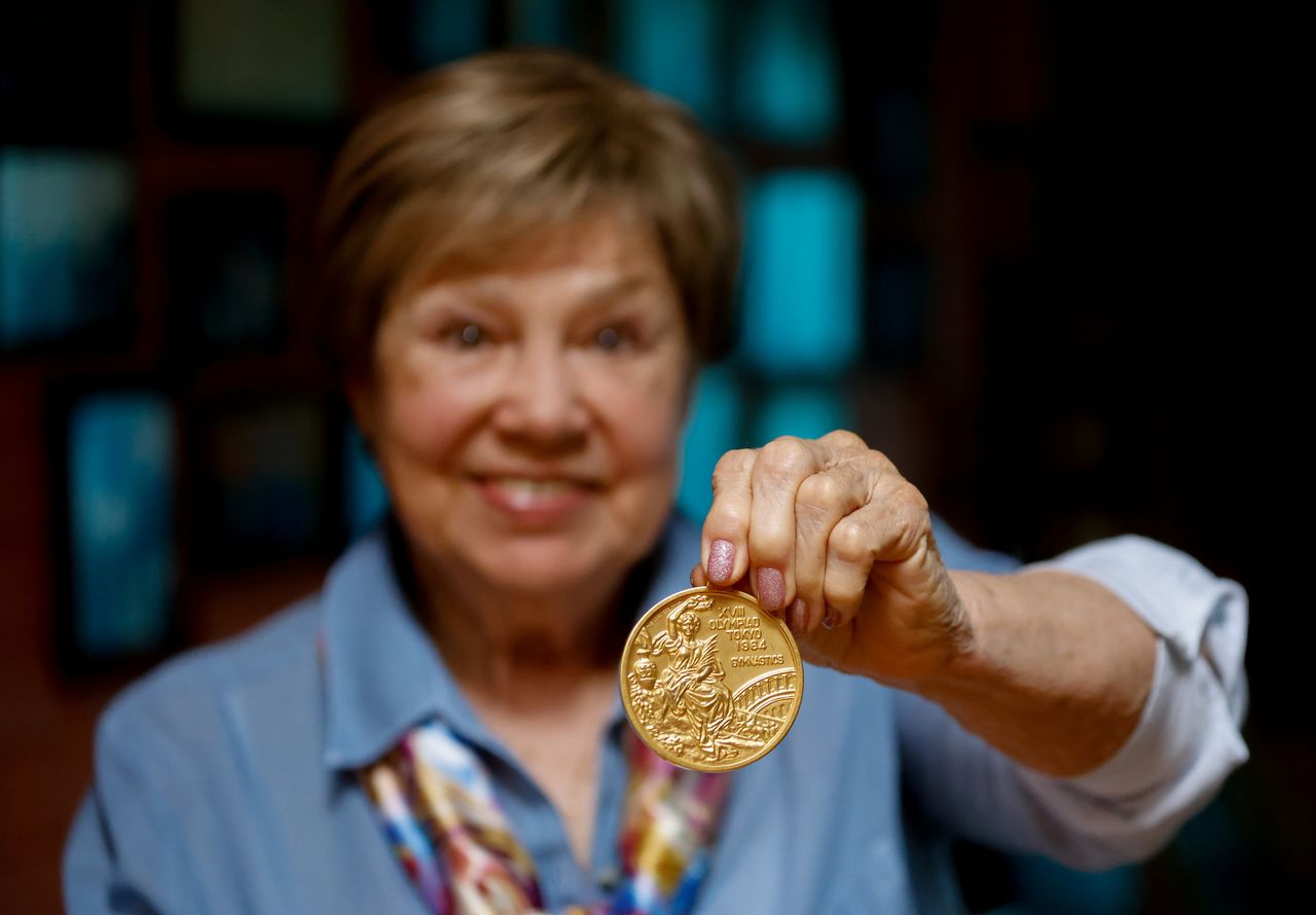 Legendary Soviet gymnast Larisa Latynina, who holds the record for the most Olympic gold medals won by a gymnast, shows her Olympic gold medal got in the Olympic Games in Tokyo in 1964, in her home in village Kalyanino, Moscow region, Russia July 30, 2021. REUTERS/Evgenia Novozhenina