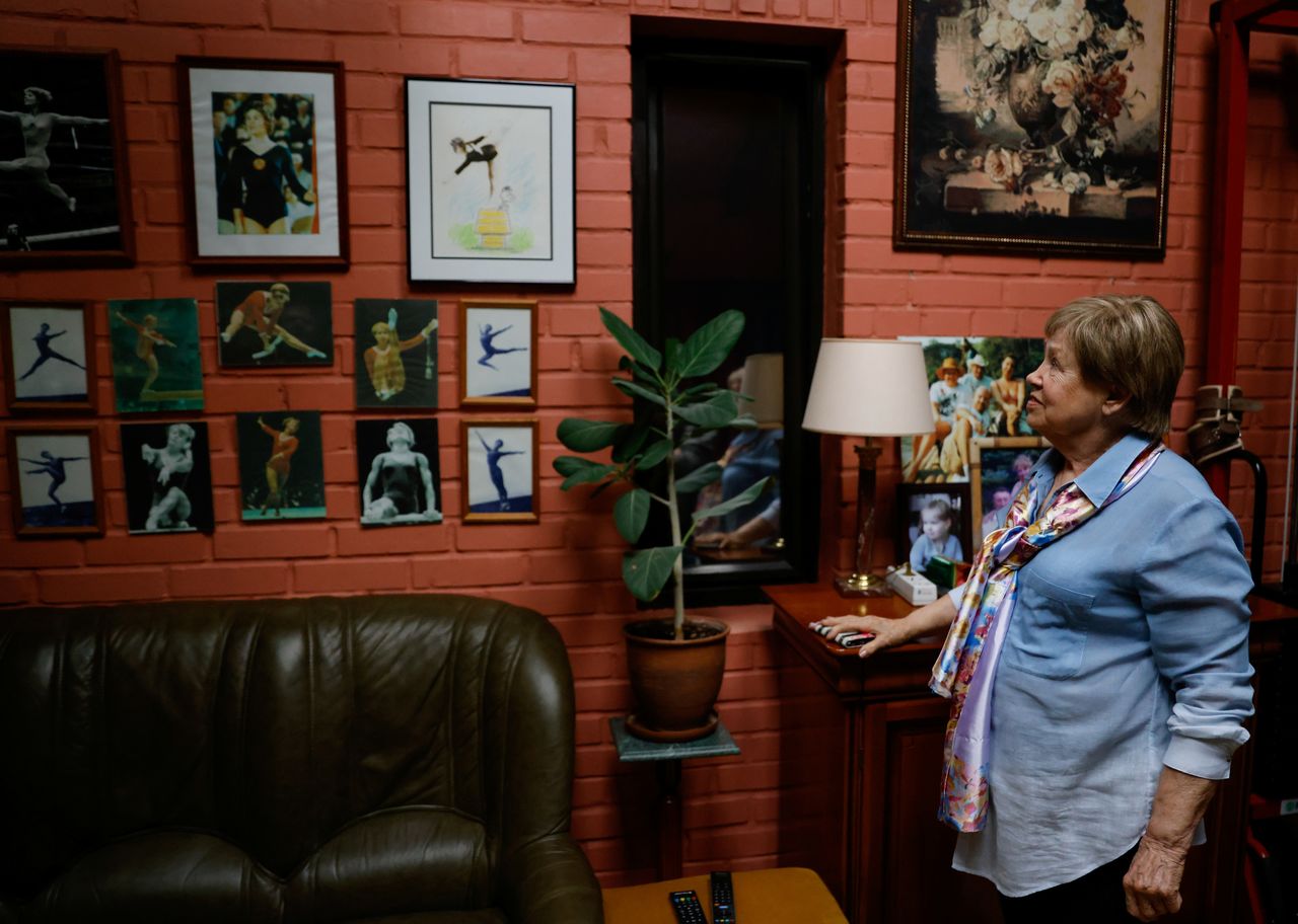 Legendary Soviet gymnast Larisa Latynina, who holds the record for the most Olympic gold medals won by a gymnast, shows her pictures in home, in village Kalyanino, Moscow region, Russia July 30, 2021. REUTERS/Evgenia Novozhenina