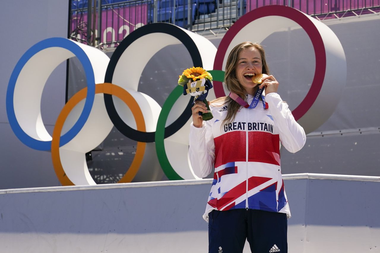 Aug 1, 2021; Tokyo, Japan; Gold medalist Charlotte Worthington (GBR)bites her medal during the BMX Freestyle during the Tokyo 2020 Olympic Summer Games at Ariake Urban Sports Park. Mandatory Credit: Michael Madrid-USA TODAY Sports