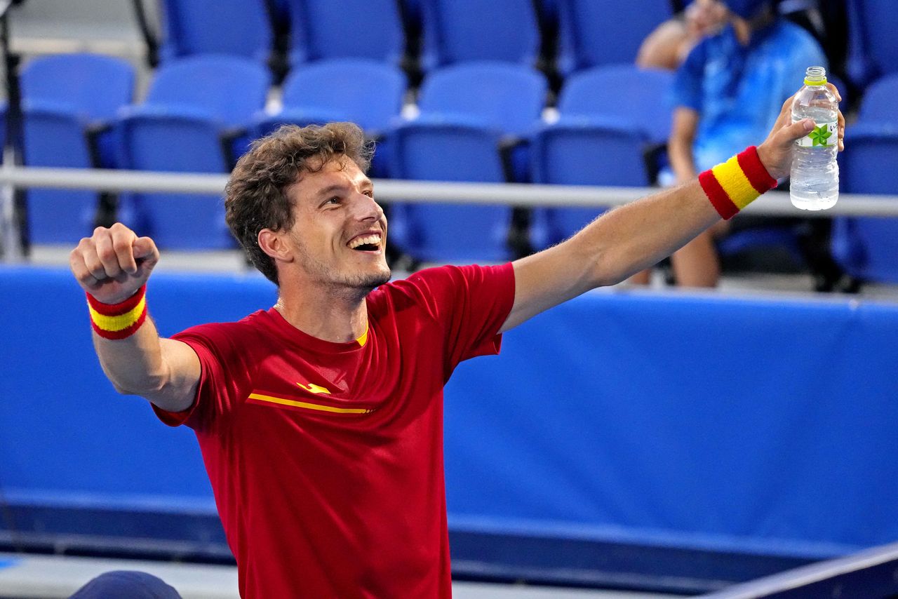Jul 31, 2021; Tokyo, Japan; Pablo Carreno Busta (ESP) celebrates beating Novak Djokovic (SRB) in the men's tennis bronze medal match during the Tokyo 2020 Olympic Summer Games at Ariake Tennis Park. Mandatory Credit: Robert Deutsch-USA TODAY Sports