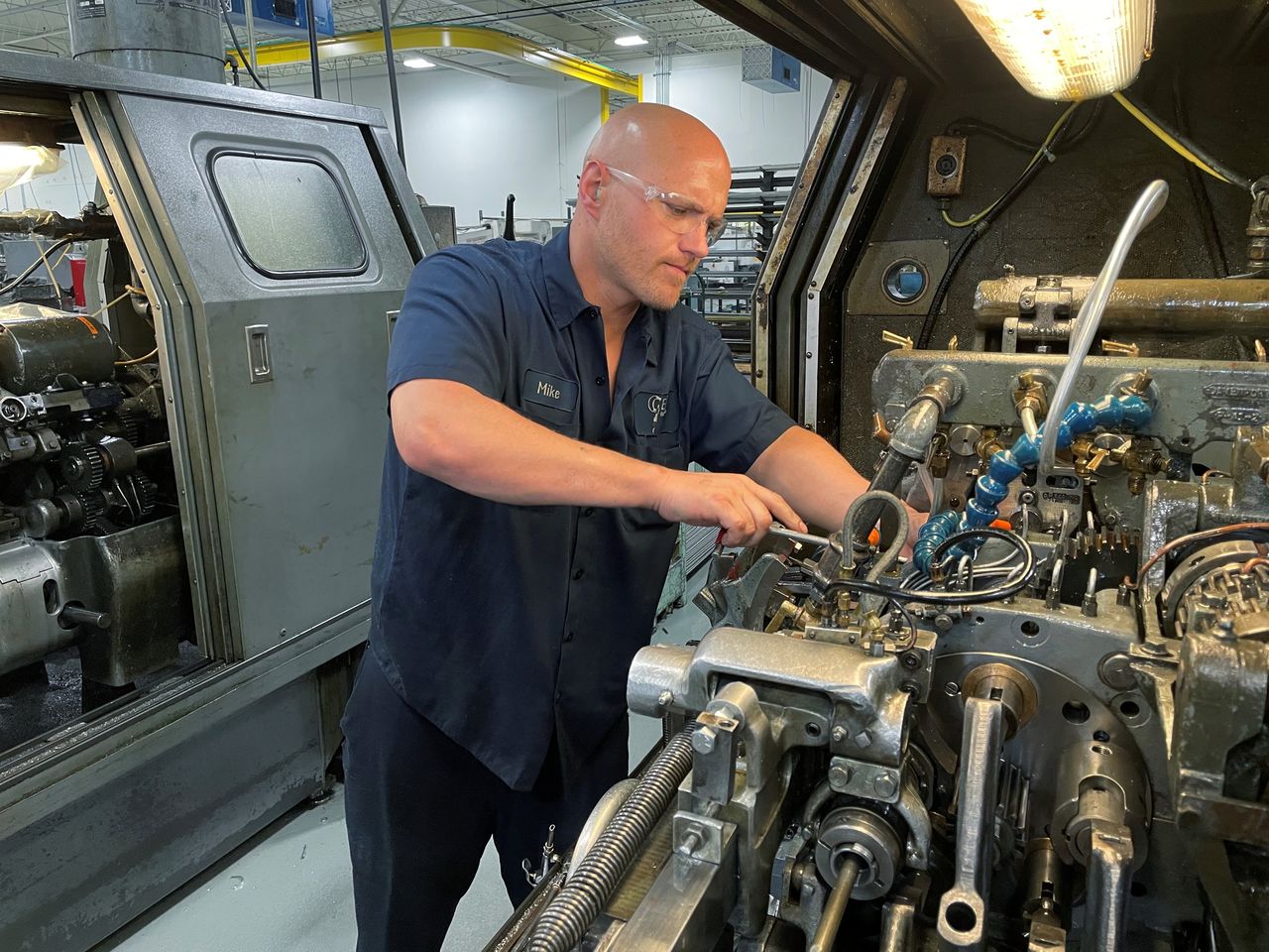A worker operates one of the metal cutting machines at Gent Machine Co.