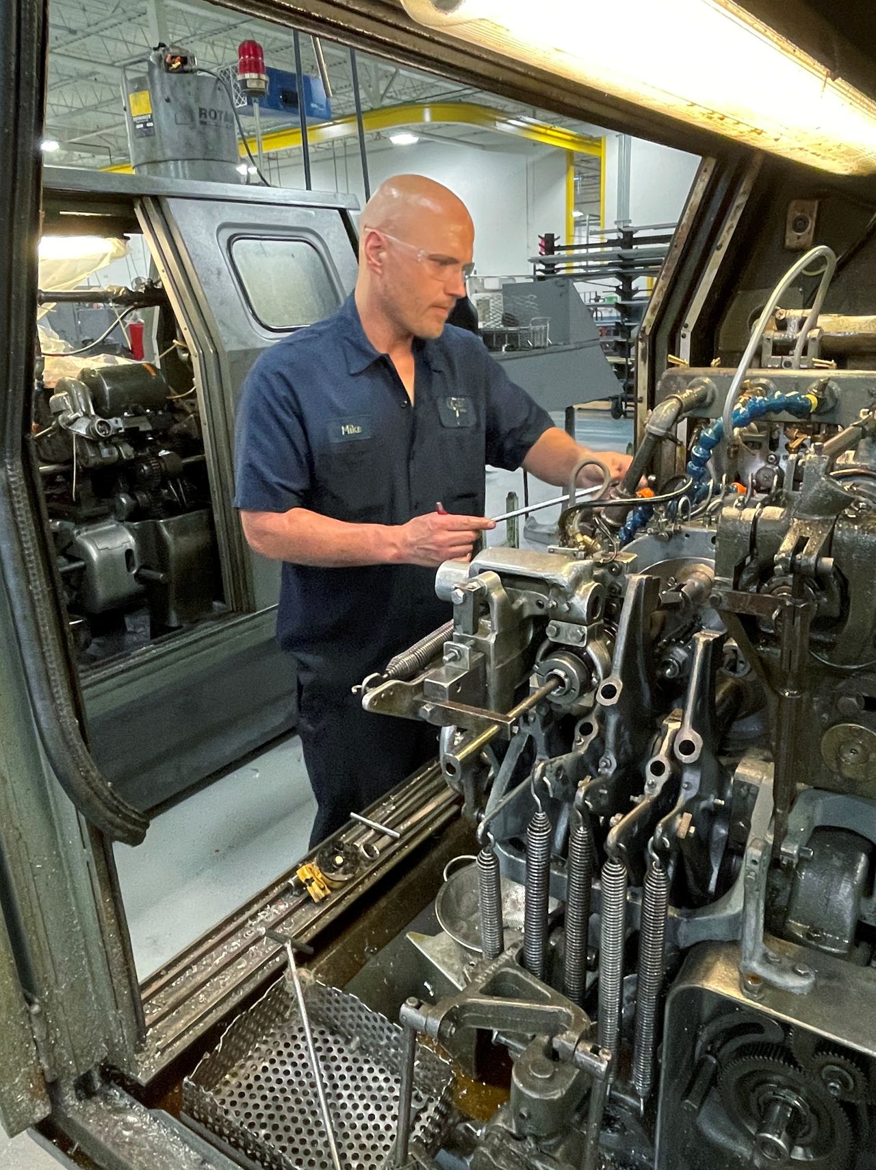 A worker operates one of the metal cutting machines at Gent Machine Co.