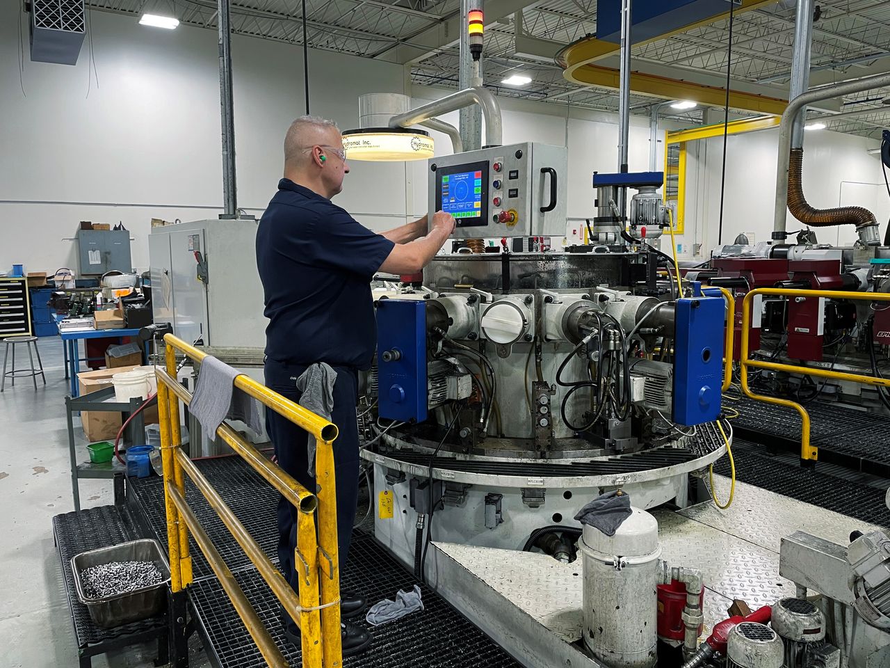 A worker operates one of the metal cutting machines at Gent Machine Co.