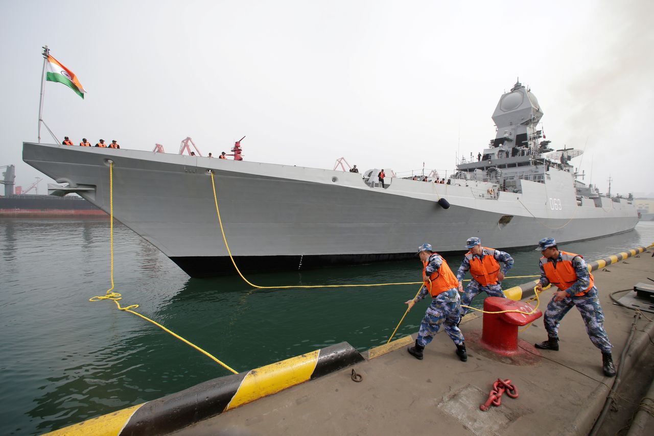 FILE PHOTO: Chinese navy personnel moor the Indian Navy warship INS Kolkata at Qingdao Port for the 70th anniversary celebrations of the founding of the Chinese People