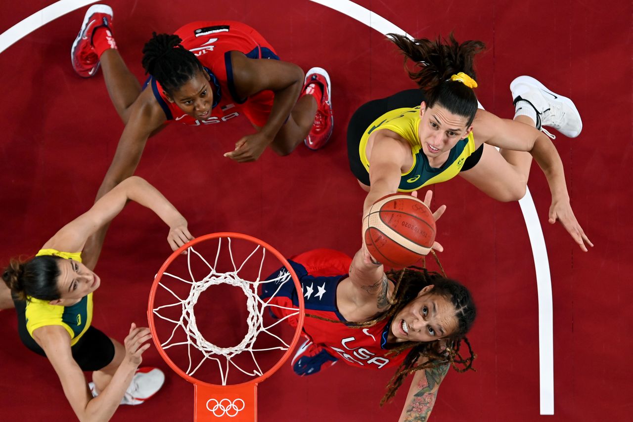 Tokyo 2020 Olympics - Basketball - Women - Quarterfinal - Australia v United States - Saitama Super Arena, Saitama, Japan - August 4, 2021. Brittney Griner of the United States in action at the rim with with Marianna Tolo of Australia Pool via REUTERS/Aris Messinis