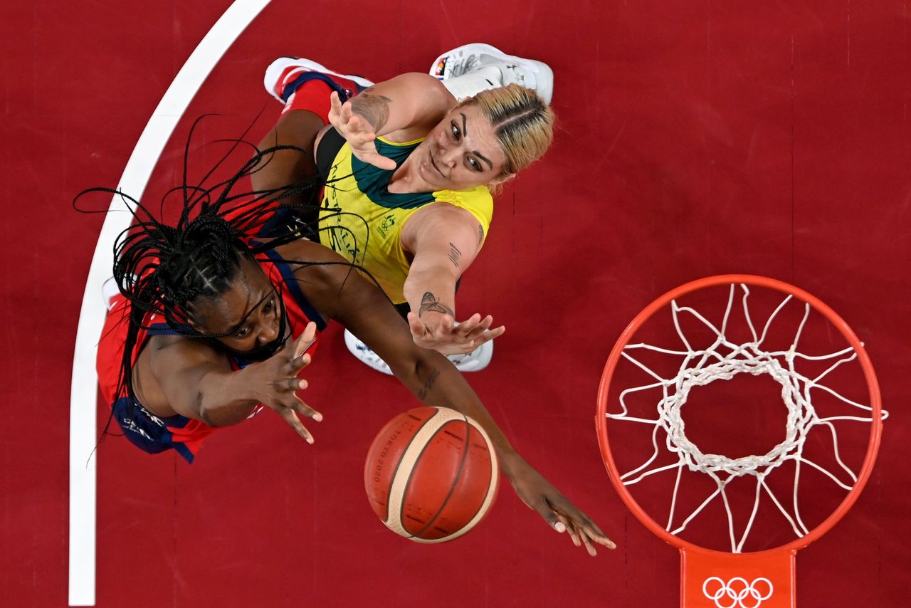 Tokyo 2020 Olympics - Basketball - Women - Quarterfinal - Australia v United States - Saitama Super Arena, Saitama, Japan - August 4, 2021. Sylvia Fowles of the United States in action at the rim with Cayla George of Australia Pool via REUTERS/Aris Messinis