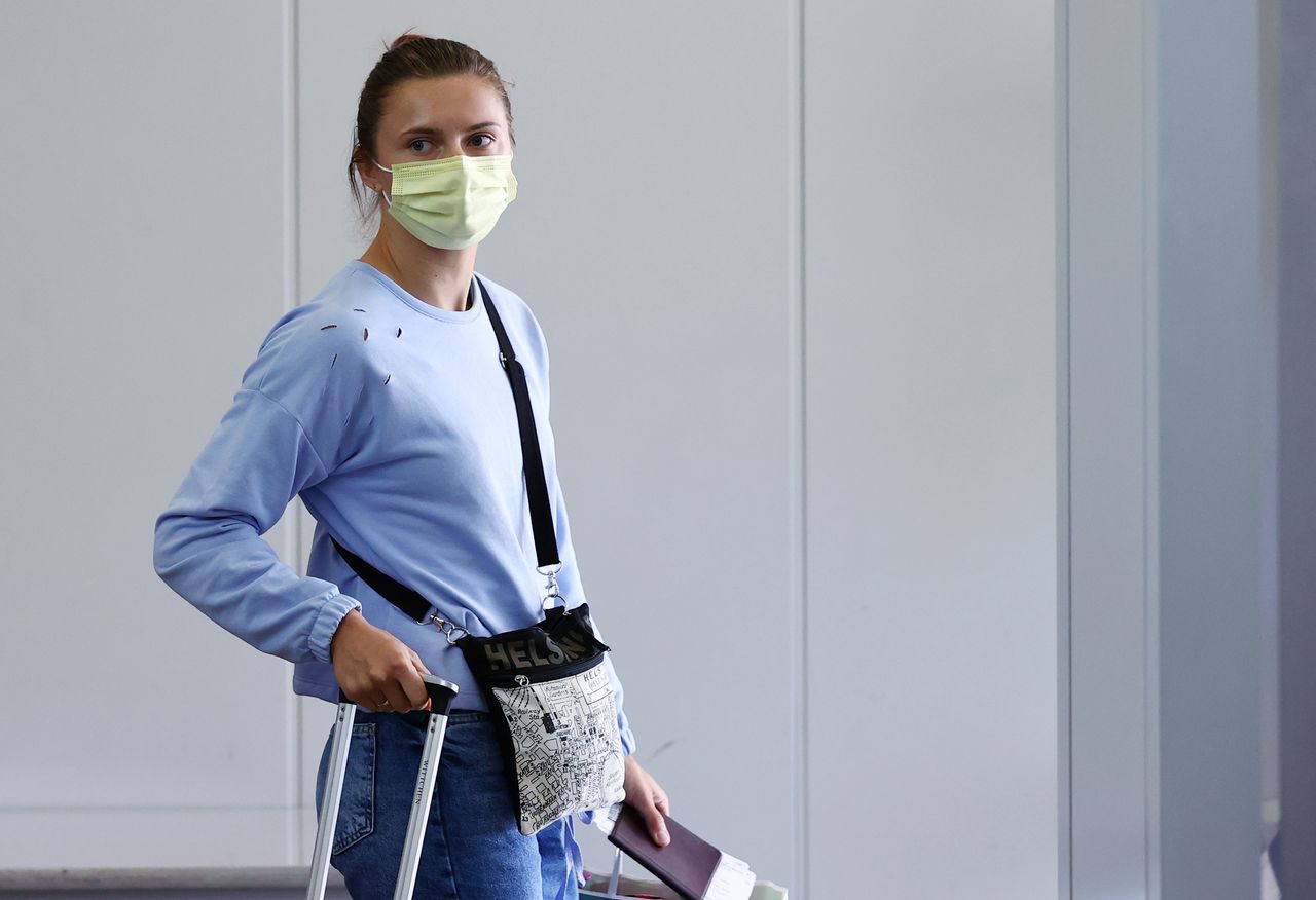 Belarusian Sprinter Krystsina Tsimanouskaya who took refuge in the Polish embassy in Tokyo, looks on while boarding a flight to Vienna at Narita International Airport in Narita, east of Tokyo, Japan August 4, 2021. REUTERS/Kim Kyung-Hoon