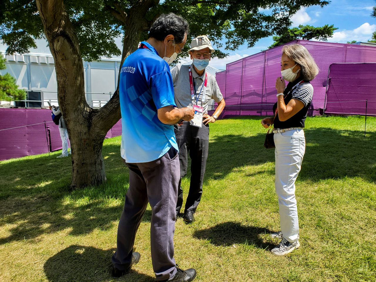 Nobuko Hirayama, a female member of a golf club hosting the Olympic golf competitions, speaks with a Tokyo 2020 Olympic Games staff member at the Kasumigaseki Country Club in Kawagoe, Saitama Prefecture, Japan August 6, 2021. REUTERS/Ju-min Park