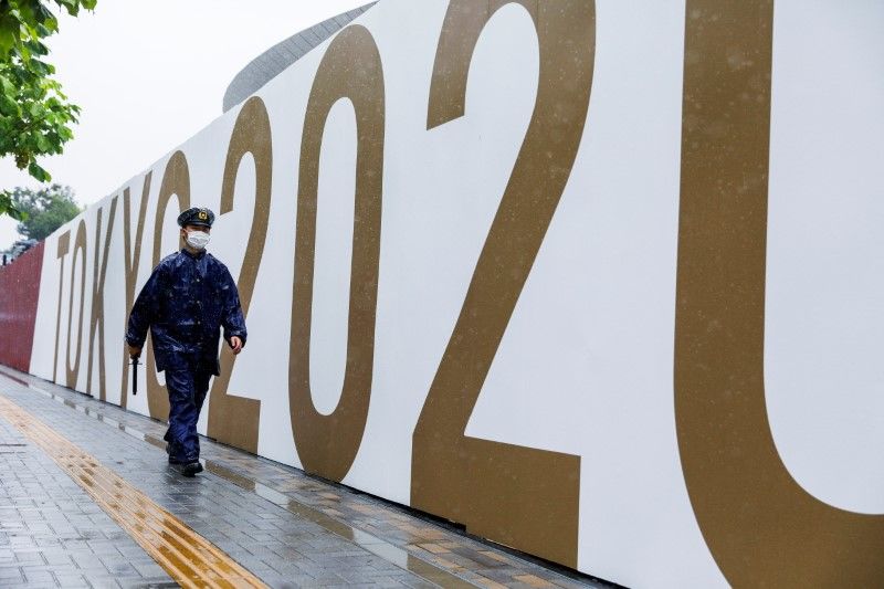 A policeman walks in front of the Olympic stadium during a typhoon, one day after the end of the Tokyo 2020 Olympic Games in Tokyo, Japan August 9, 2021. REUTERS/Androniki Christodoulou