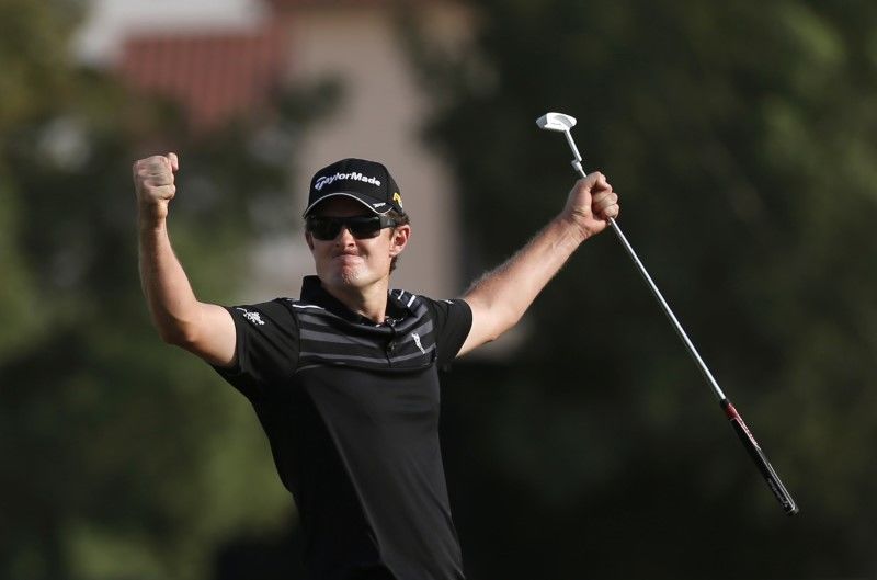 FILE PHOTO: Justin Rose of England reacts at the 18th green during the fourth and final round of the DP World Tour Championship at Jumeirah Golf Estates in Dubai November 25, 2012. REUTERS/Jumana El Heloueh