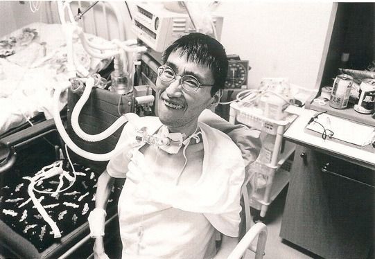 Shikano connected to a mechanical ventilator following a tracheotomy operation in 1995. (© Takahashi Masayuki)