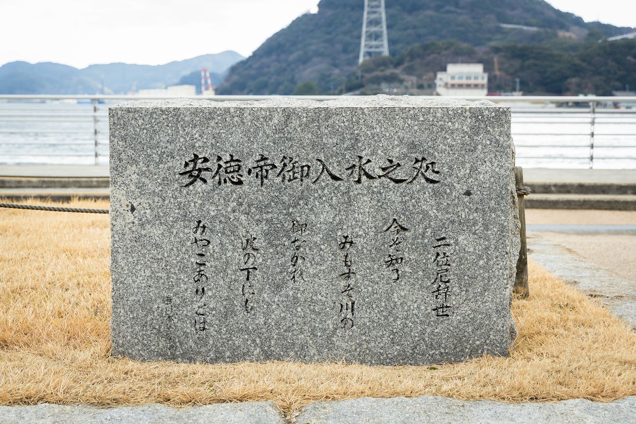El monumento de piedra del lugar donde el Emperador Antoku se lanzó al mar. El poema de despedida de la monja Nii fue el origen del nombre de la aldea.