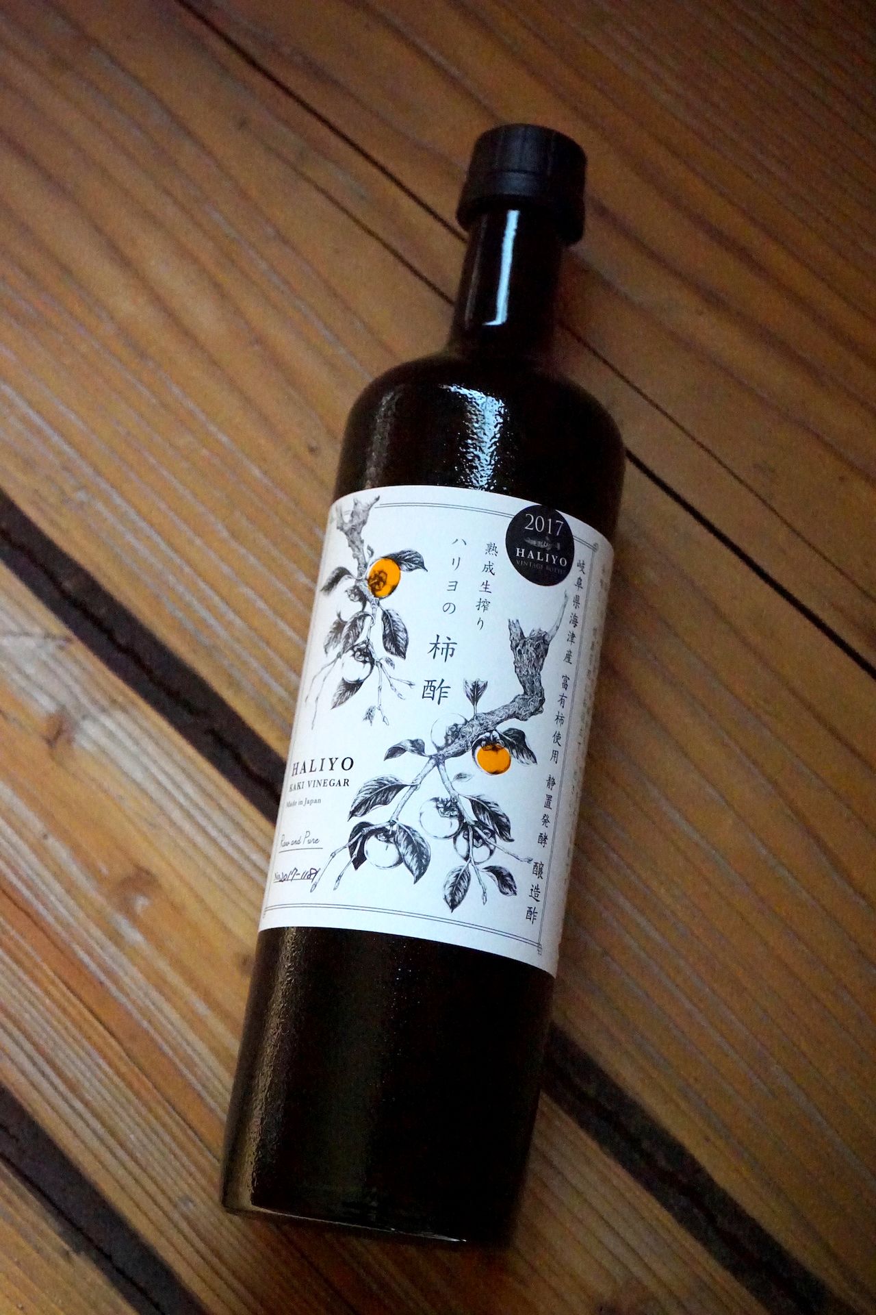 El llamativo envase del vinagre de caqui Haliyo. Cada botella muestra el año de producción, ya que las diferentes cosechas varían sutilmente de sabor. (© Ukita Yasuyuki)