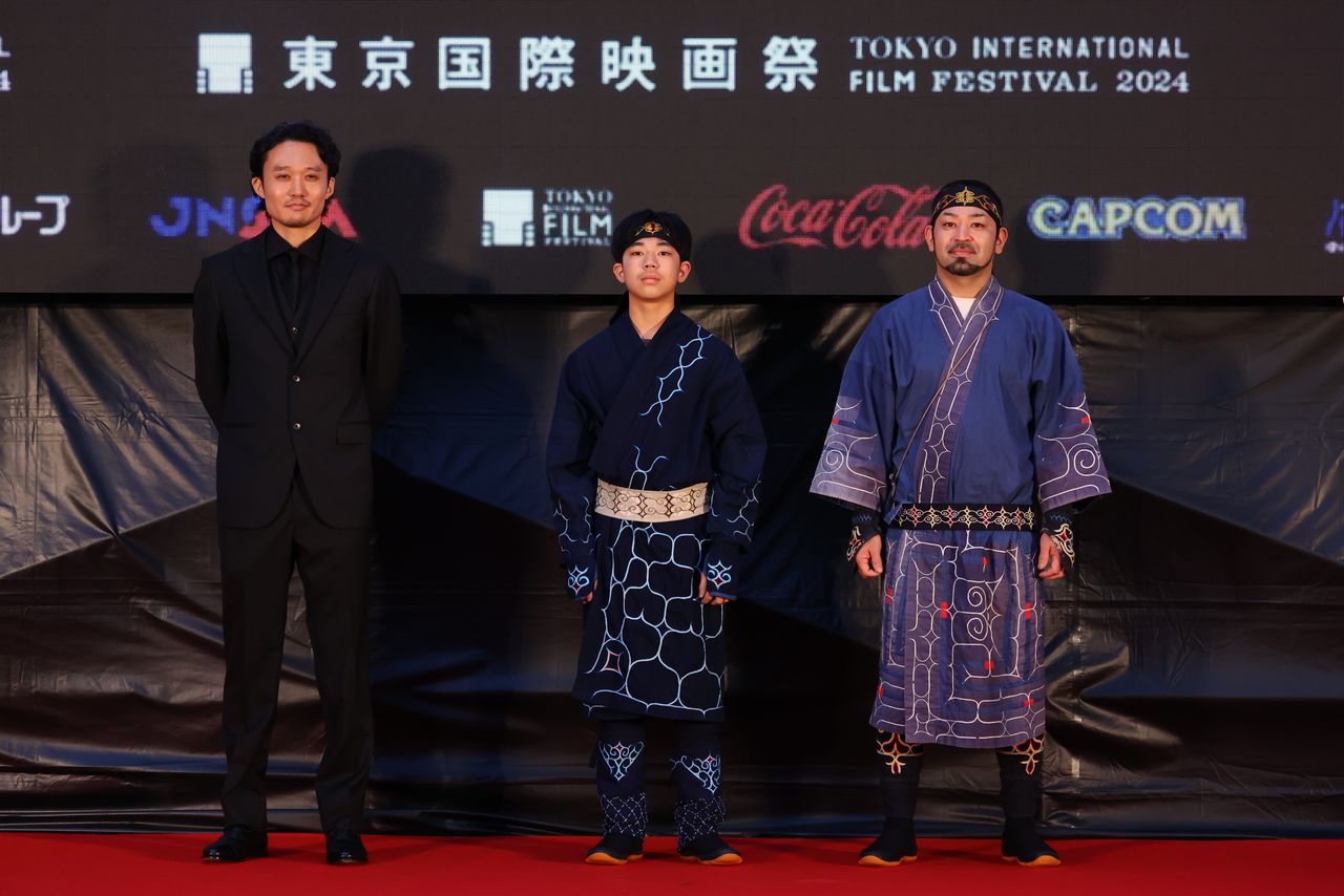 El director de Ainu puri, Fukunaga Takeshi (izquierda), con los actores Amanai Shigeki (derecha) y Amanai Motoki en la alfombra roja del Festival Internacional de Cine de Tokio el 28 de octubre de 2024. (© 2024 TIFF)