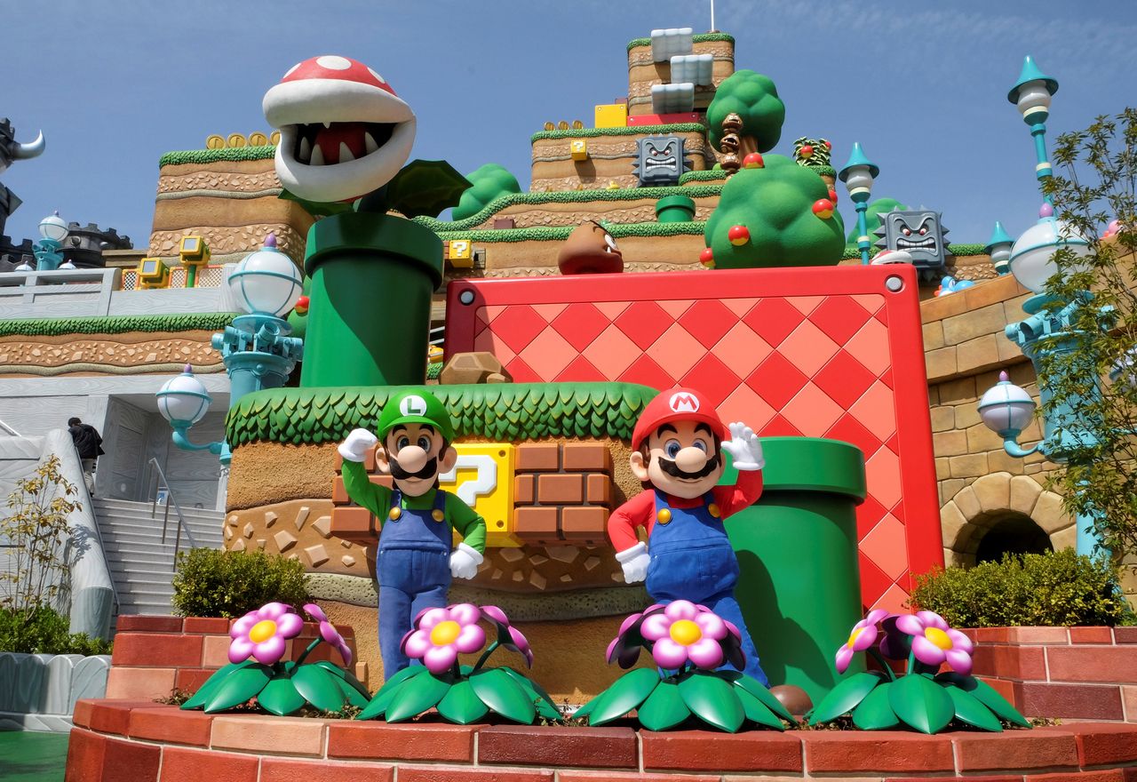 FILE PHOTO: Mario and Luigi characters greet visitors in front of Yoshi