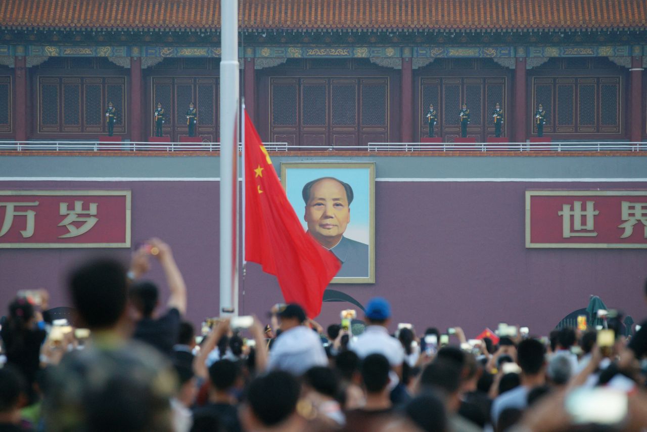 FOTO DE ARCHIVO: Los visitantes observan una ceremonia de izado de bandera mientras sale el sol en la Plaza de Tiananmen, en el aniversario de la fundación del Partido Comunista Chino, en Pekín, China el 1 de julio de 2018.