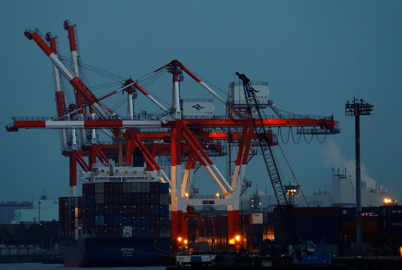 A cargo ship and containers are seen at an industrial port in Tokyo, Japan, February 15, 2022. REUTERS/Kim Kyung-Hoon