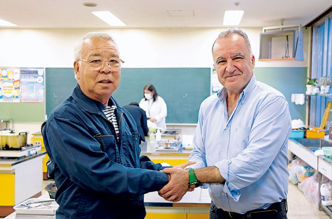 El presidente de la Asociación Ainu de Shiraoi, Yamamura Kazuyuki (izquierda) estrecha la mano de Mariano Gómez, presidente honorario de la Asociación de Slow Food.
