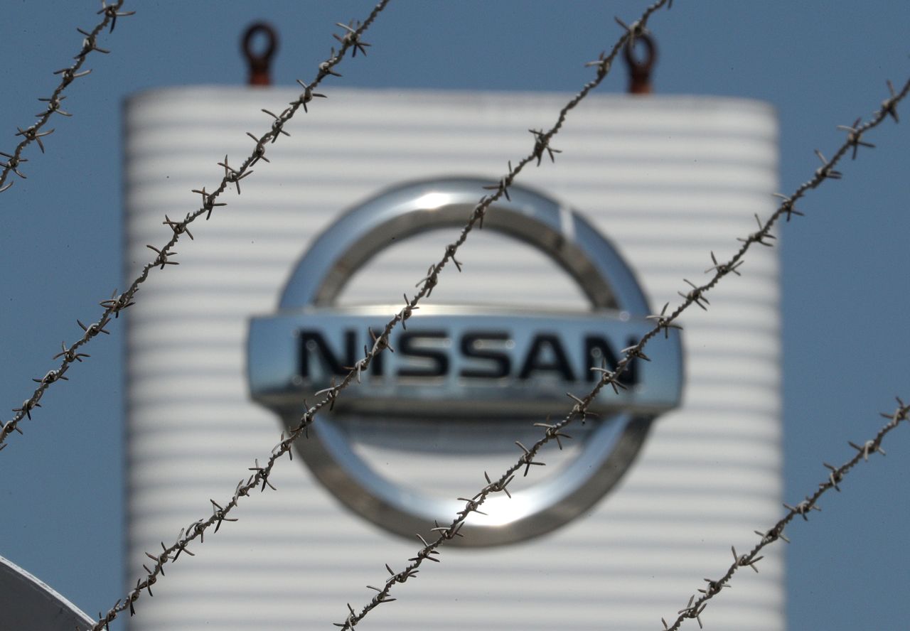 FILE PHOTO: The logo of Nissan is seen through a fence at Nissan factory at Zona Franca during the coronavirus disease (COVID-19) outbreak in Barcelona, Spain, May 26, 2020. REUTERS/ Albert Gea