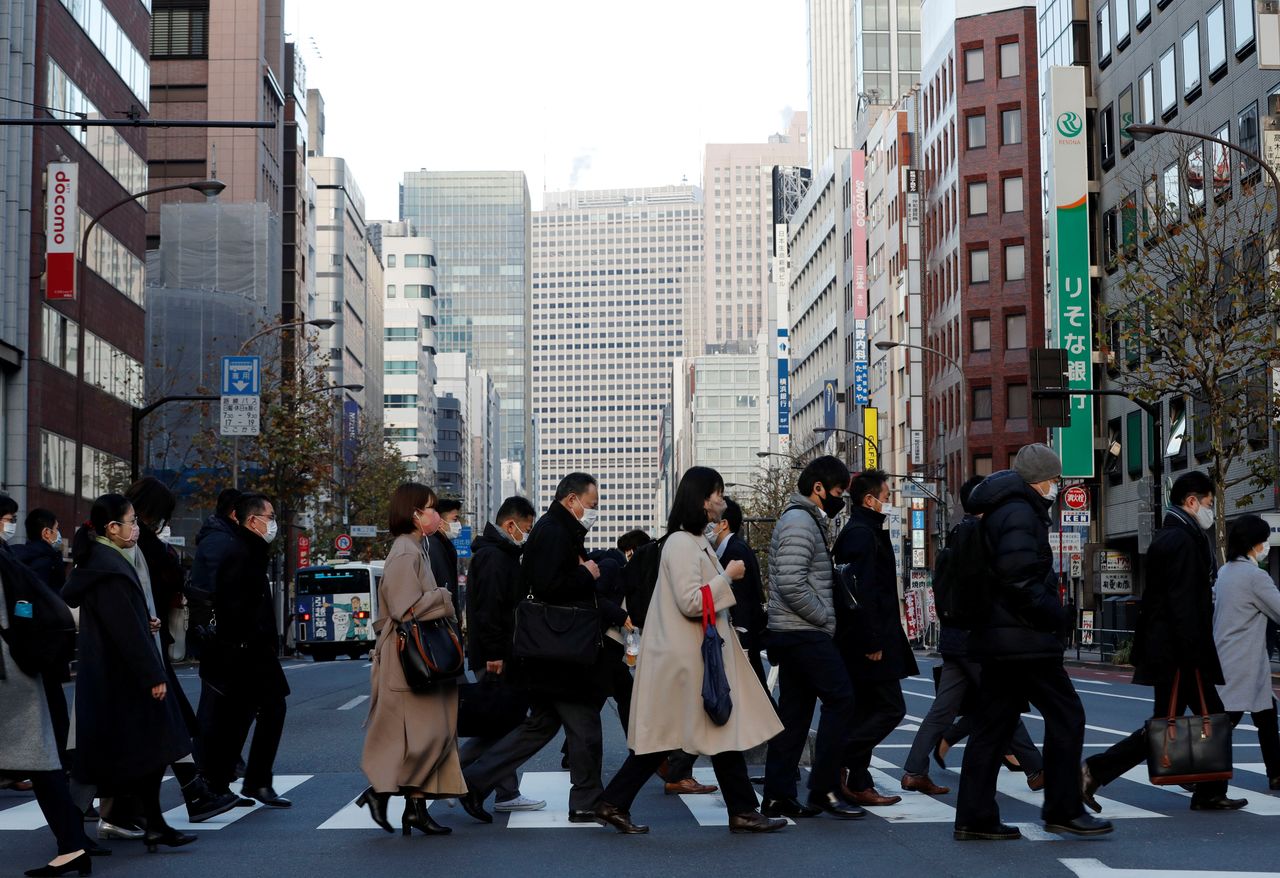 FOTO DE ARCHIVO: Peatones con mascarilla cruzan una calle en un distrito de negocios de Tokio, Japón, el 7 de enero de 2021. REUTERS/Kim Kyung-Hoon
