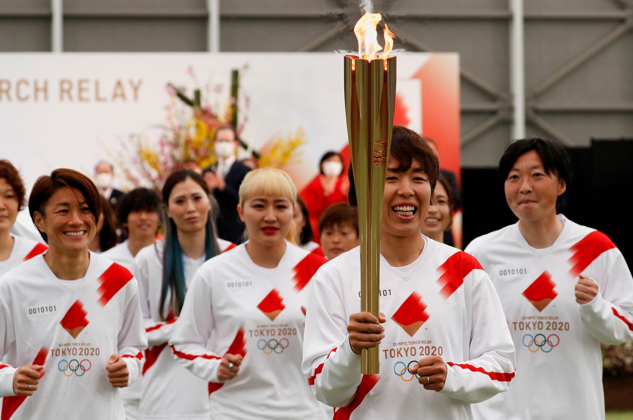 Foto de archivo. Parte del equipo nacional de futbol femenino porta la antorcha olímpica en Naraha, prefectura de Fukushima. Japón, 25 de marzo de 2021. REUTERS/Kim Kyung-Hoon/Pool
