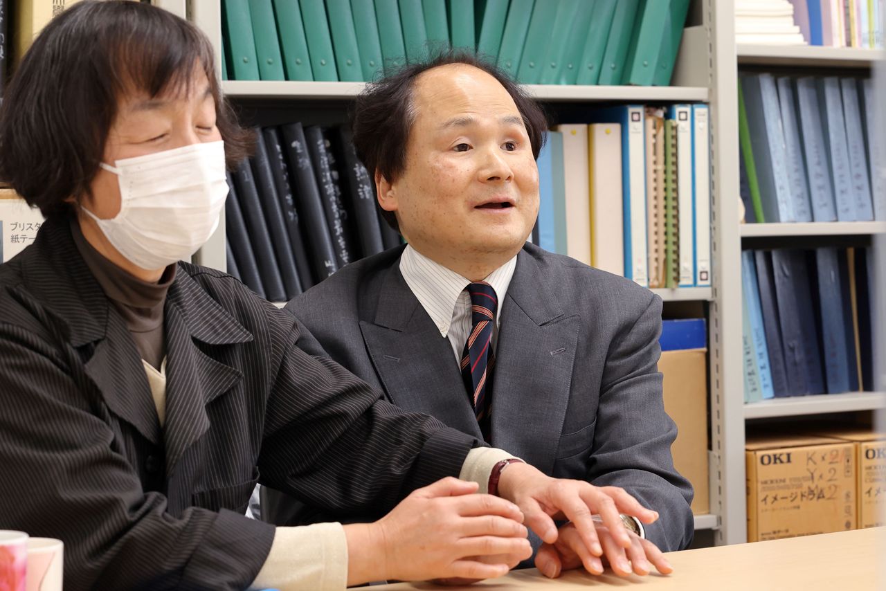 En el braille dactilar la intérprete (Haruno Momoko, a la izquierda) percute los dedos de Fukushima, que puede así comprender lo que le dicen.