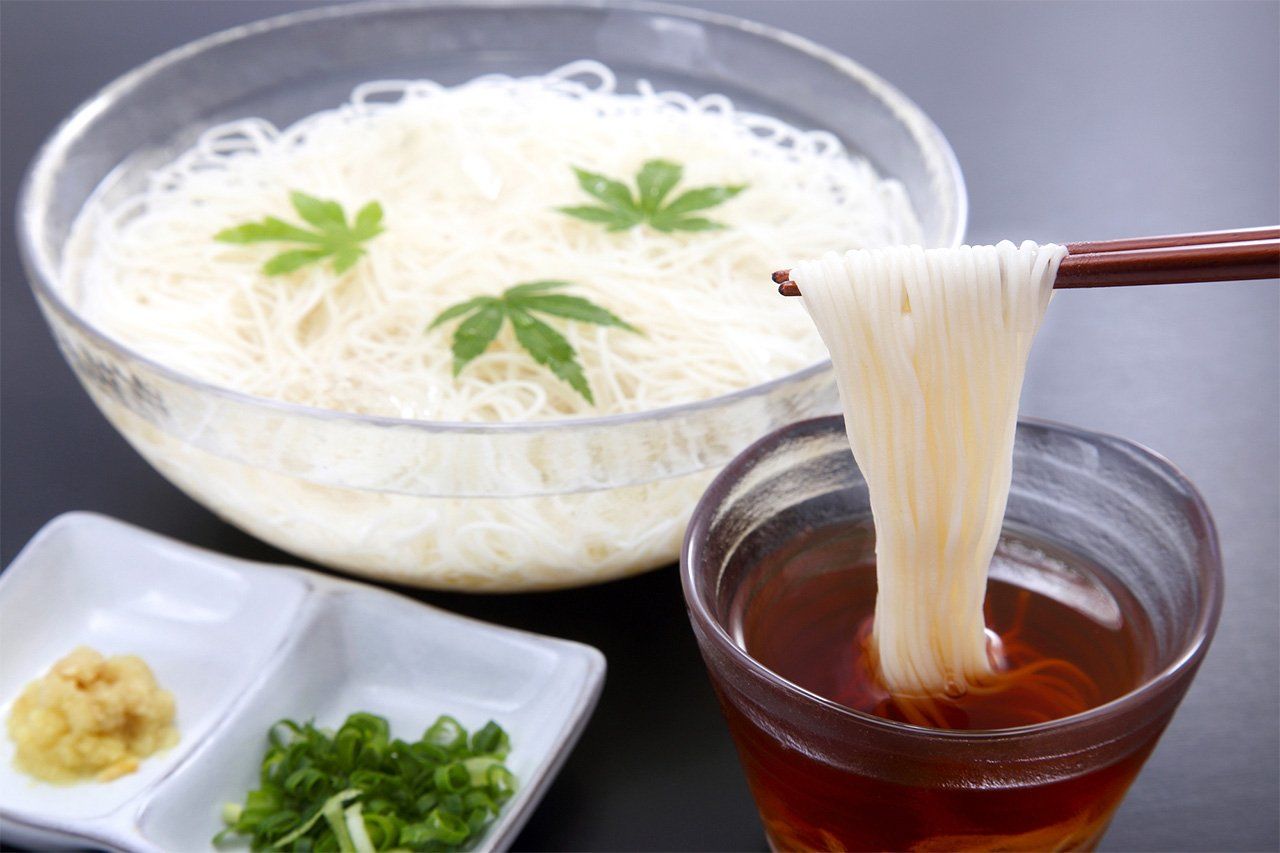 Un bol de nouilles de blé (sômen) froides avec, de droite à gauche, la sauce spéciale (tsuyu), la ciboule japonaise (negi) et le gingembre (shôga) râpé qui leur servent traditionnellement d’accompagnement.