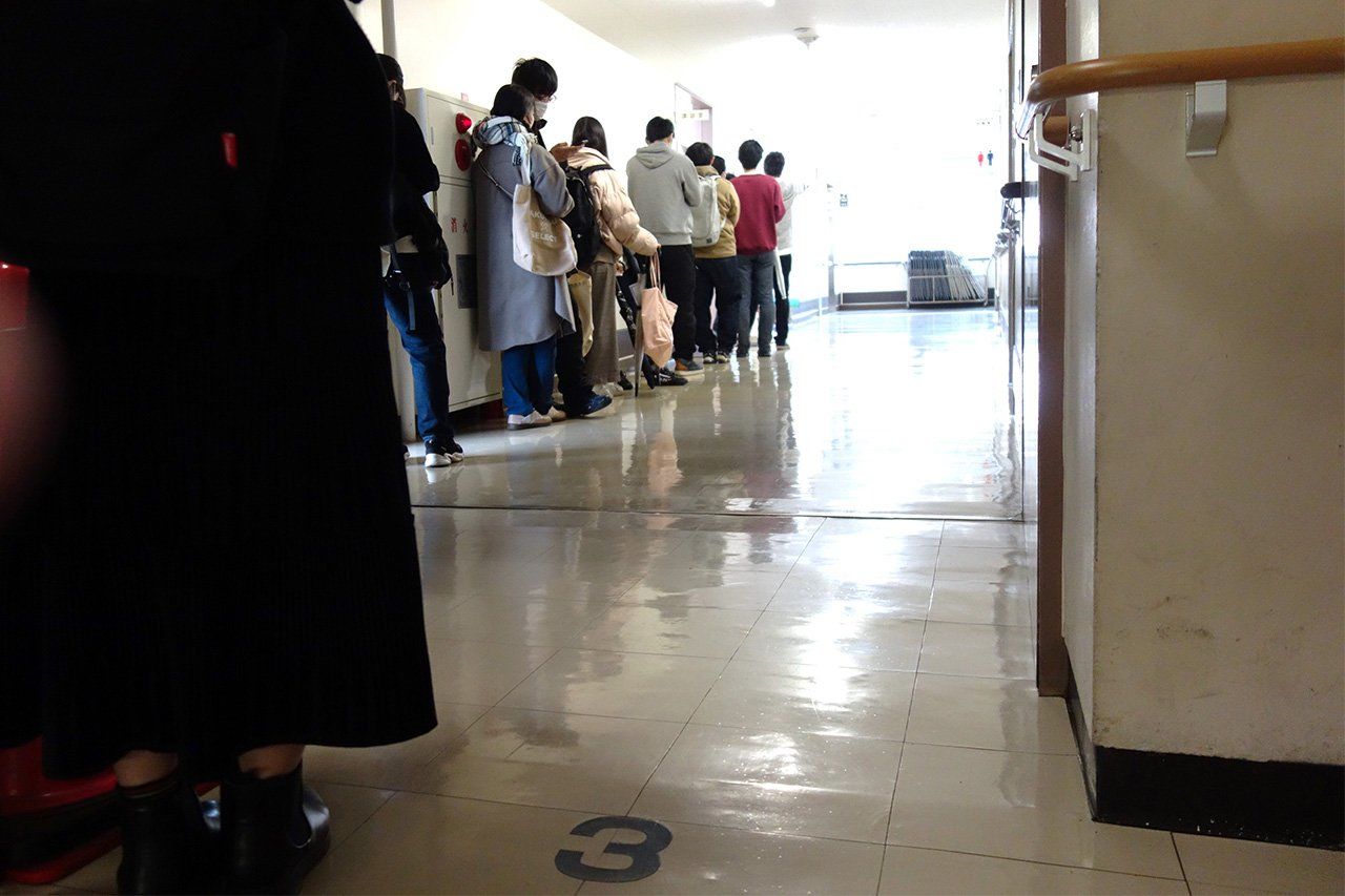 Des étudiants font la queue pendant un événement à la banque alimentaire Food Bank Kanagawa. (© Nippon.com)