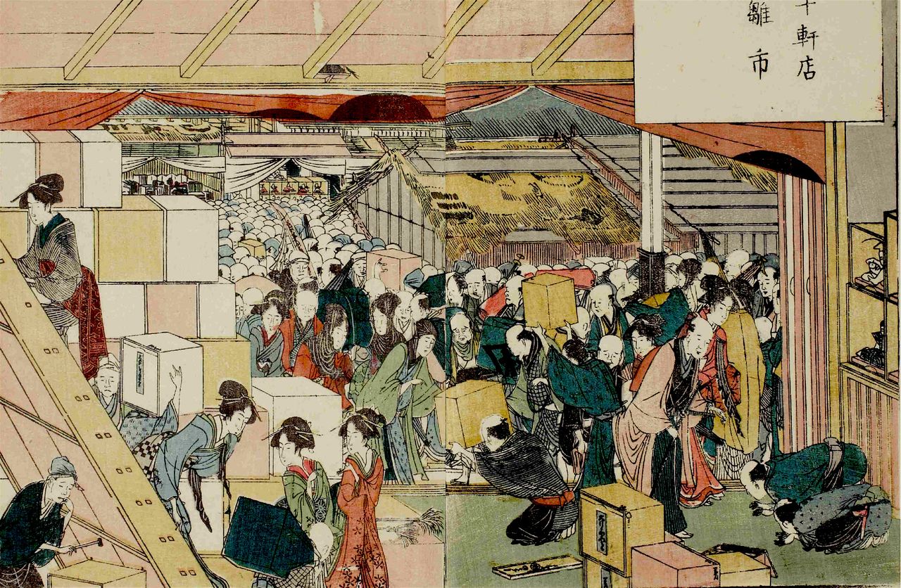 Marché aux poupées de Jikken-dana. Celles-ci se trouvent dans les boîtes empilées sur la gauche. Ces commerçants, qui vendaient habituellement d’autres marchandises, ne faisaient du négoce de poupées qu’à l’occasion de ce marché et louaient alors des emplacements. (« Livre illustré des lieux de plaisance à Edo », Ehon Azuma Asobi, Collections spéciales, Bibliothèque centrale de la métropole de Tokyo)